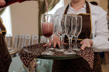 Glasses with white sparkling wine on a tray