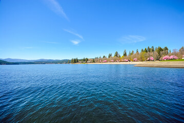 A beautiful sandy beach along the shores of Lake Coeur d'Alene at spring time at city beach and Independence Point in Coeur d'Alene, Idaho	