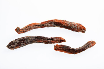 Rotting and moldy carrot with black spots isolated on white