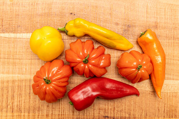 Ecological sweet peppers and tomatoes on a wooden table