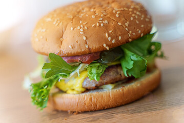 Handmade hamburger on the wooden table.