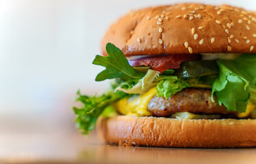 Rustic handmade hamburger on the wooden table.