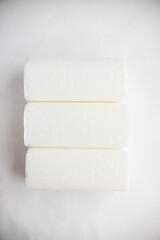 rolls of paper towels, napkins on a white background. White on white, pulp, paper, hygiene. The concept of conscious consumption, sustainable lifestyle. High quality photo