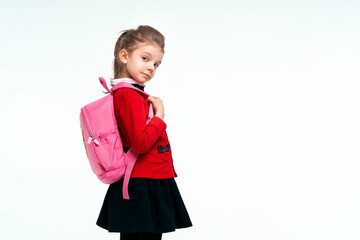 Adorable little girl in red school jacket, black dress, on to th
