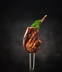 Grilled pork meat with bone on fork