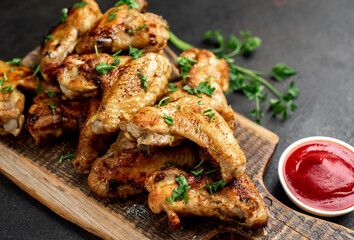 grilled chicken wings with spices on a stone background
