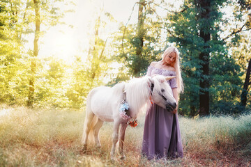 Woman in purple dress hugging white unicorn horse. Dreams come t
