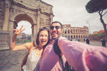 Romantic couple in Rome, Italy. A men and a women, they are taking selfie funny photo in front of...