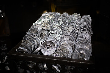 Aluminum workpieces of electric motors in dirty container at outdated factory