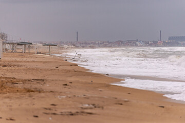 Deserted beaches of Feodosia in winter. Wide beach and storm at sea. A beach that is waiting for...