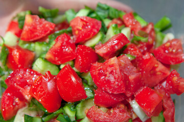 Fresh salad of tomatoes and cucumbers . Lettuce sprinkled with salt