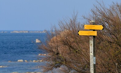 Direction sign for hikers on the GR34 path in Brittany. France