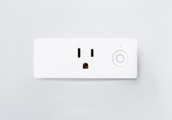 Modern smart plug and wifi outlet. Minimal design of electricity with on off control switch for save energy on a wall. Inactive electric power device installed on white background.