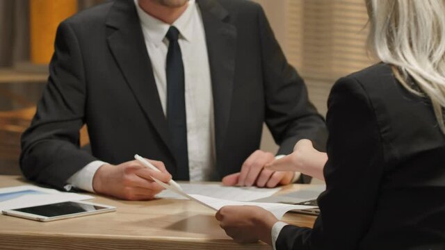 Partners are discussing terms of contract. Woman indignantly ripping contract to pieces. Termination of a contract, rejecting paper, rip deal. Close up. Slow motion ready, 4K at 59.94fps.