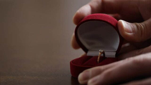 hand holding a wedding ring. Lvoe concept. Wedding golden ring. 