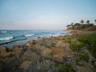 Fototapeta na wymiar Rocky Cliffs and surf beach. Dominican Republic. Wide angle shot.