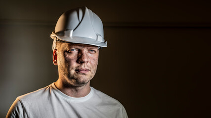 working man construction worker with dirty face looking at camera Close up portrait