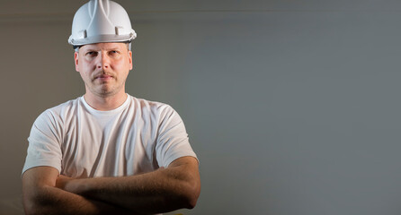 working man portrait close-up in a construction helmet