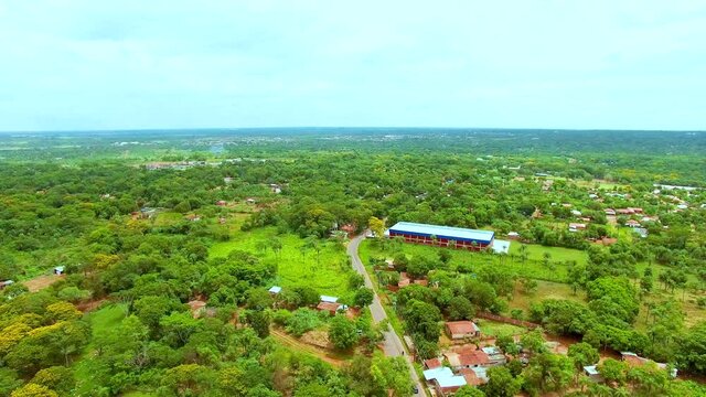 aerial view of area with a lot of nature, town, few houses, nature