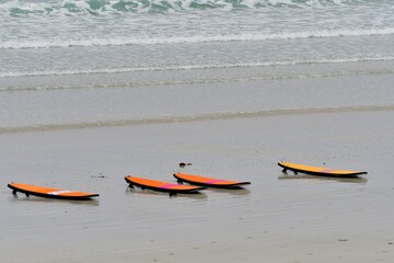 Orange surfboards on a beach at Trestel in Brittany. France