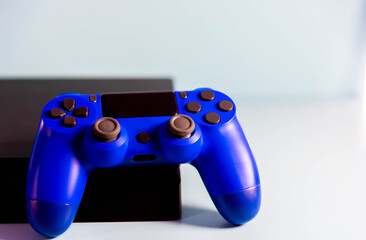 Controls and video game console on light background