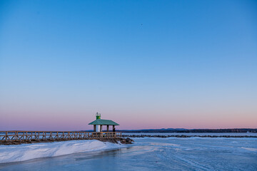 Sunrise seen from the Pembroke Marina on the frozen  Ottawa River in March at a temperature of...