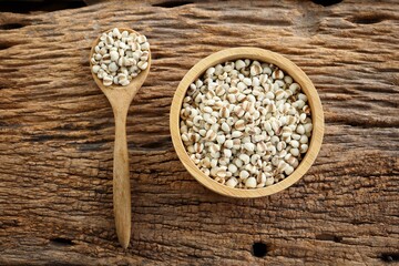 White millet seed raw in wood bowl on table