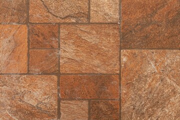 Building exterior brown granite block wall texture and background seamless