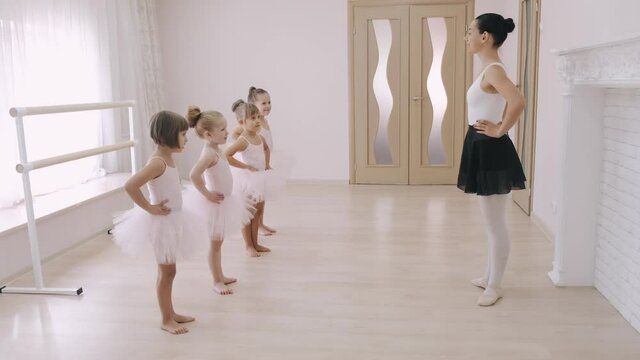 Young students ballerinas in choreography class of ballet school