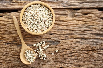 White millet seed raw in wood bowl on table
