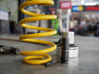 maintaining a car shock absorbers at garage.