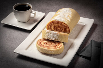 Deliciou roll cake with black coffee.
