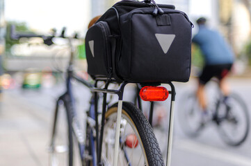 Close-up of illuminated bicycle tail light installed on bicycle rear rack