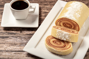 Delicious roll cake with guava jam and a cup of black coffee.