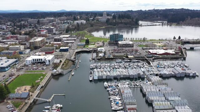 Cinematic aerial drone video of the springtime cherry blossoms at the Washington State Capitol Building and Campus, Capitol Lake, with a panoramic view of Historic District in Olympia, Washington