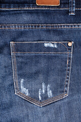 Blue worn jeans pocket close up, ripped jeans pocket background, dark blue damaged denim backdrop,...