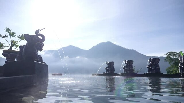  Natural hot spring Toya Devasya beside Batur volcano. Infinity pool with elephant figures. Popular travel destination 