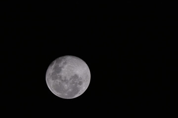 Naklejka na ściany i meble view of a full moon at night