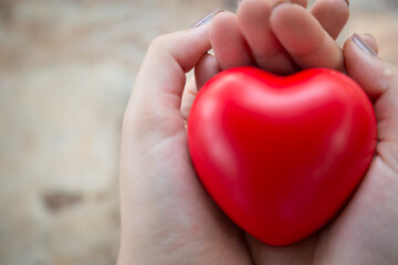 Fototapeta premium Woman holding red hearts to encourage COVID-19 patients