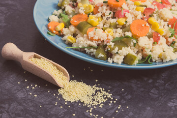 Salad with vegetables and couscous groats. Light and healthy meal containing vitamins and minerals