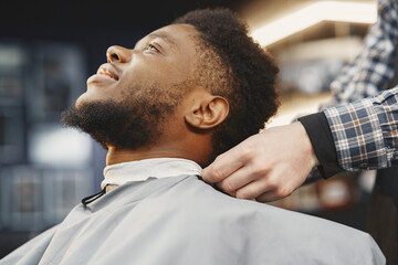Young African-american man visiting barbershop