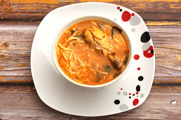 Bowl with chicken soup on wooden table. Delicious homemade healthy food.