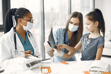 Fototapeta premium Doctor examines a little girl in hospital