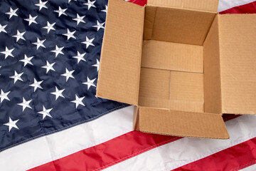 USA flag and open shipping box. Delivery from the USA.