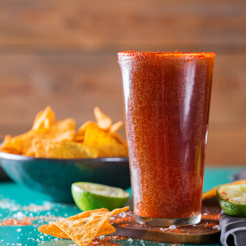 Mexican alcohol cocktail michelada with dark beer and lime juice