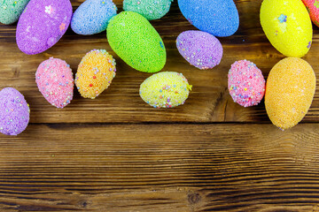 Easter eggs on rustic wooden background. Top view, copy space