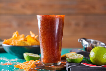 Mexican alcohol cocktail michelada with dark beer and lime juice