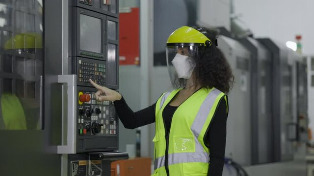 Electrical engineer check machine equipment. Wear protective equipment. Safety hard hat to prevent accidents. Face Mask to prevent dust, COVID-19 in operation Or industrial Factory.