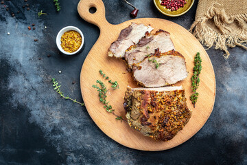 Roasted sliced Christmas ham of turkey. large piece of baked pork with mustard on a cutting board. banner, menu recipe place for text, top view