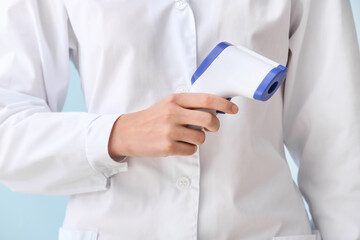 Doctor with infrared thermometer, closeup